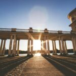 Capturing the dramatic sunset through majestic columns in Rheinsberg.